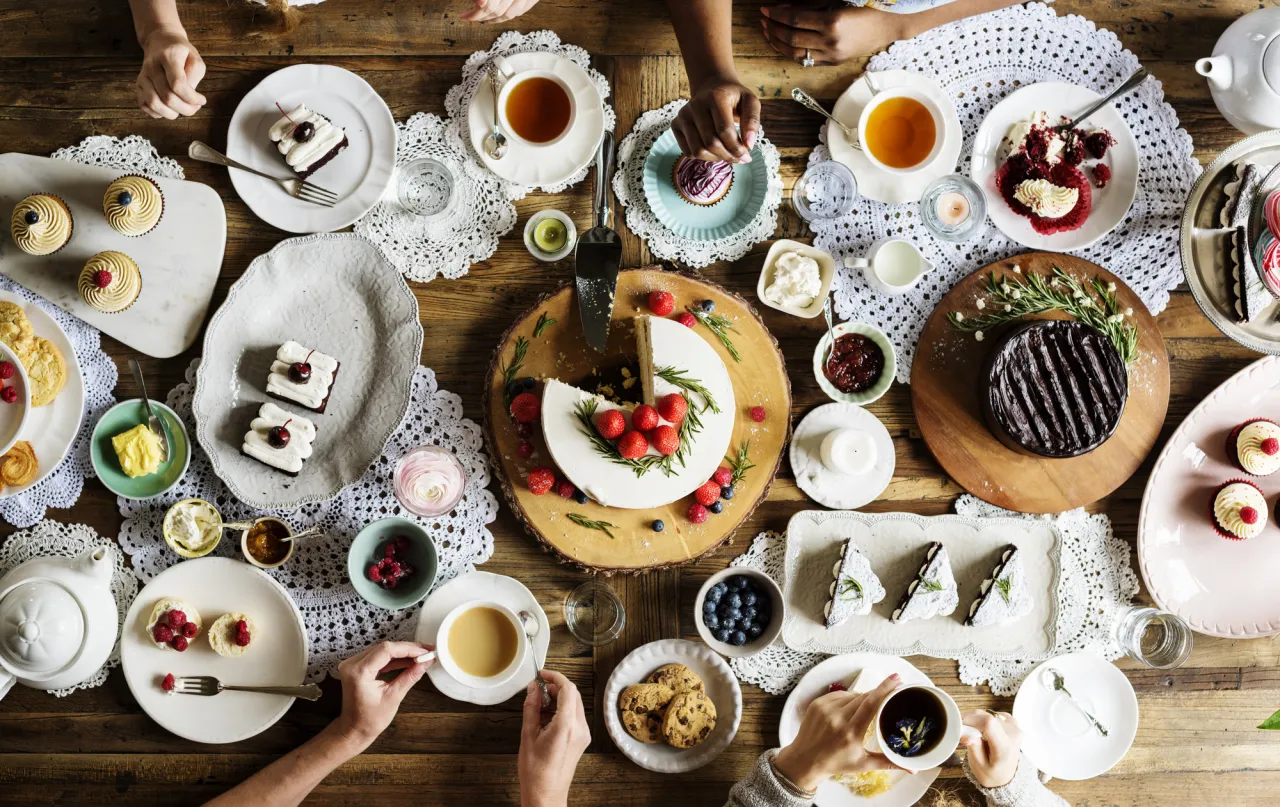 Friends Gathering Together on Tea Party Eating Cakes