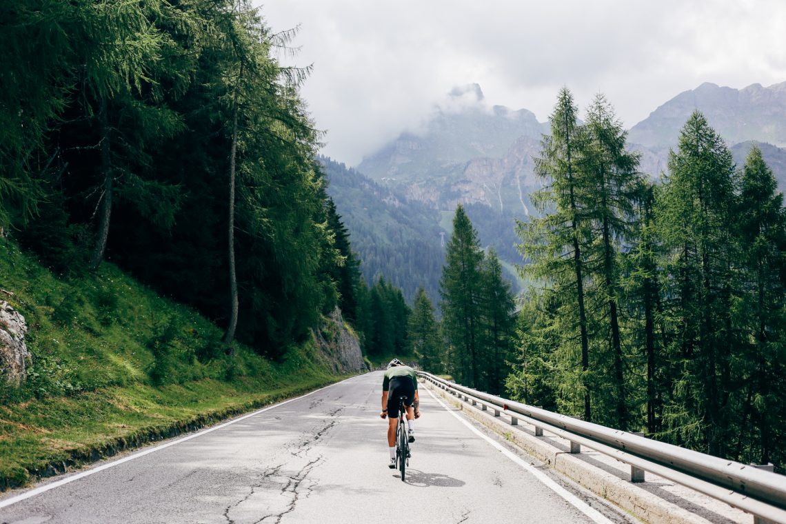 Professional road cyclist on cycling trip in alps