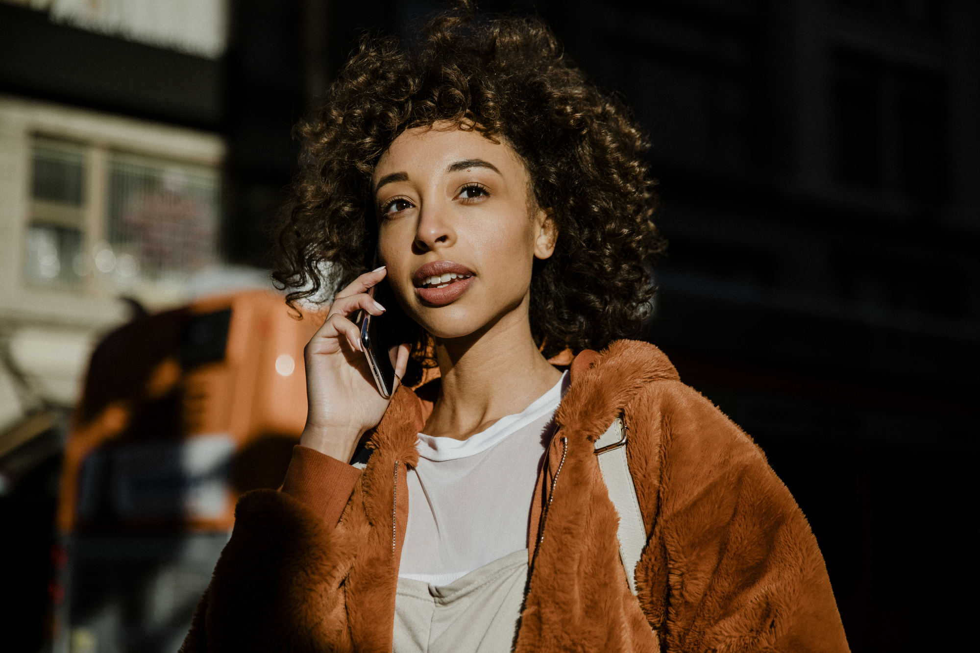 Black woman making a call in downtown