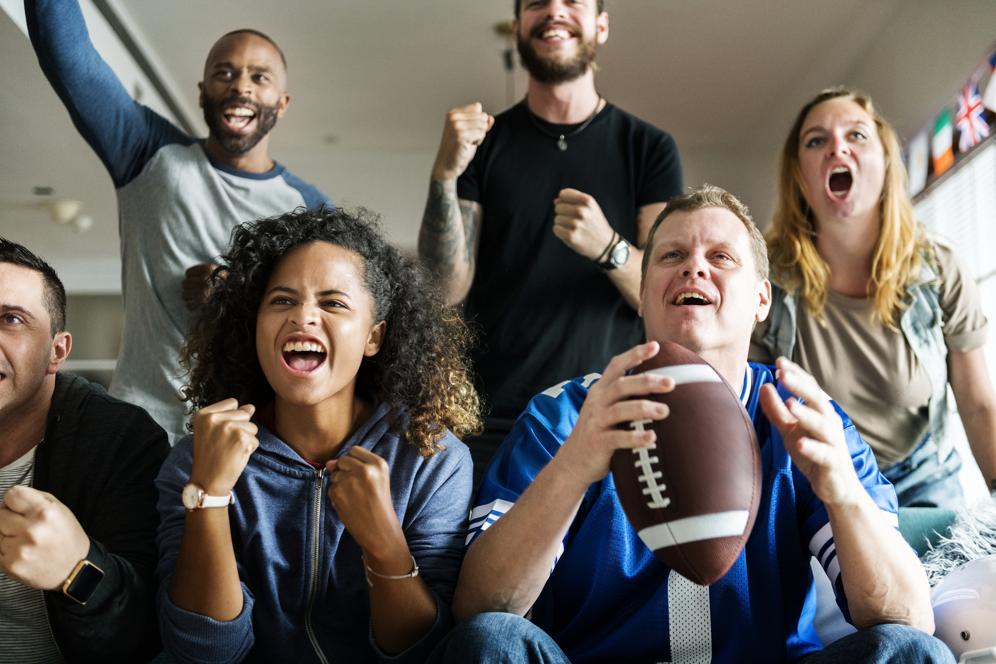 Friends cheering sport league together