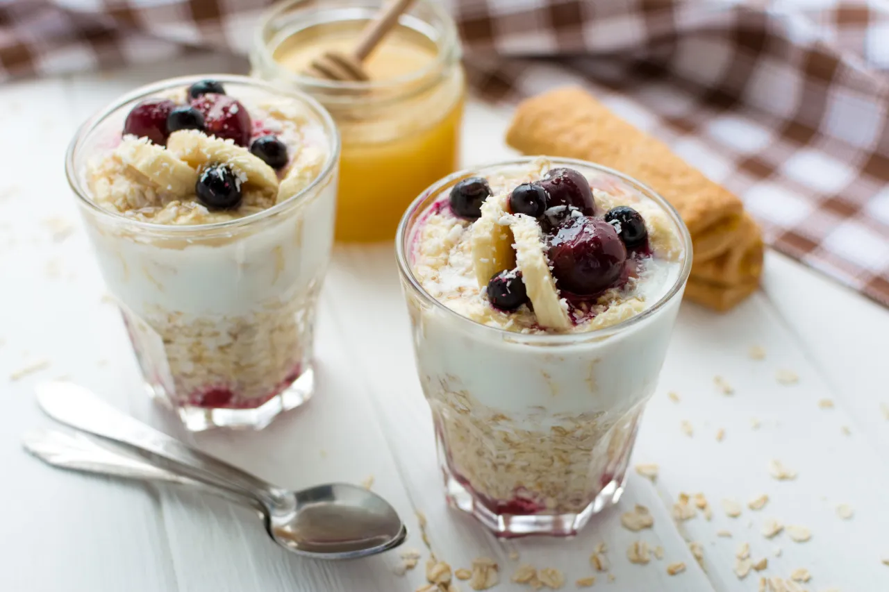 Healthy breakfast. Oatmeal with bananas, berries and honey