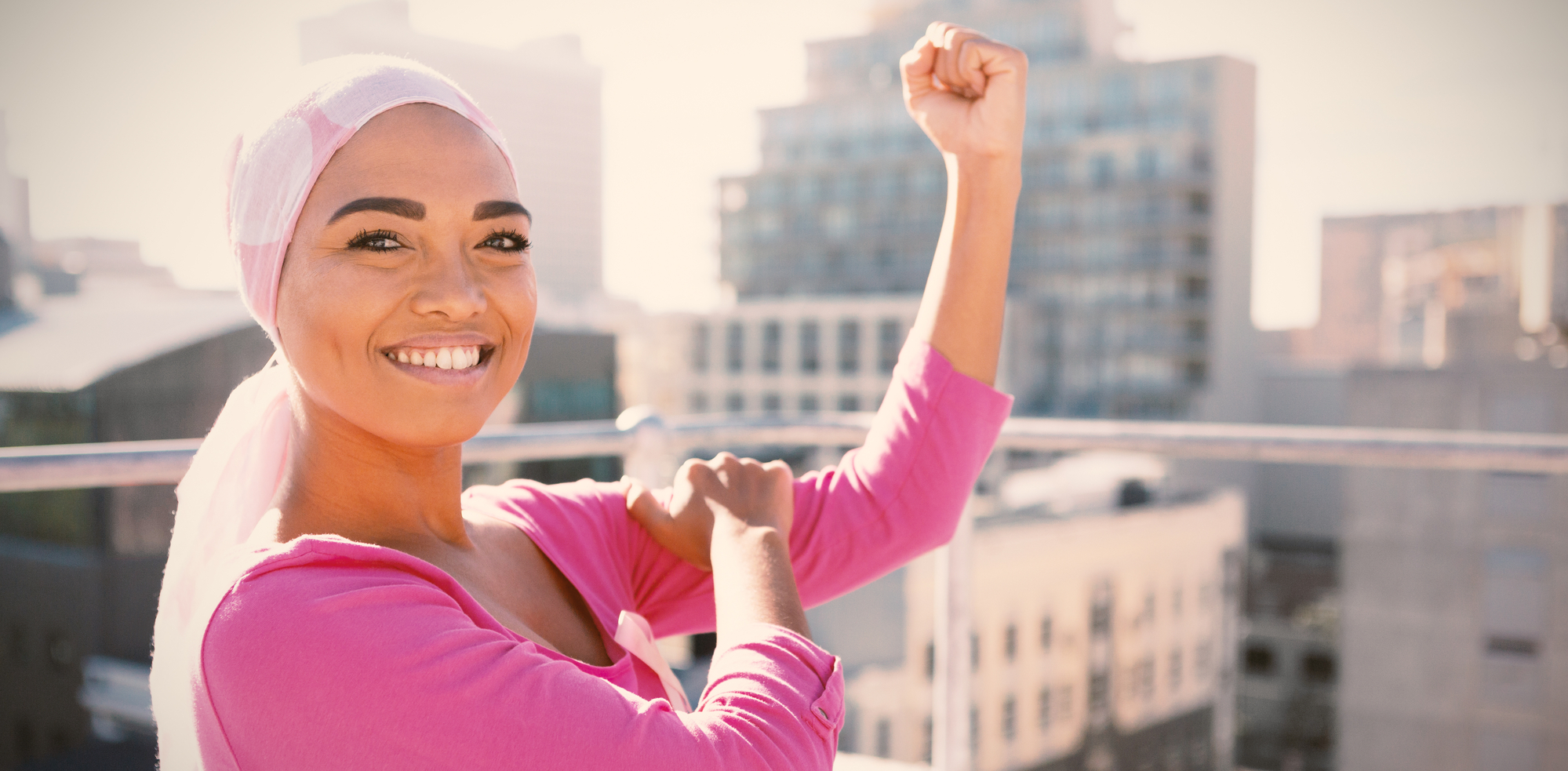 Strong woman wearing mantra scarf in the city with breast cancer awareness