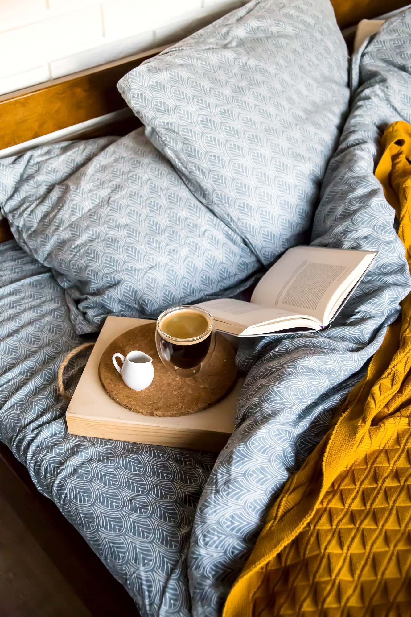 Black coffee in a transparent cup in bed in the autumn morning