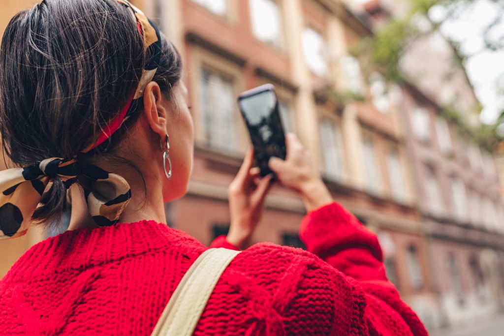 Young woman with a phone outdoors