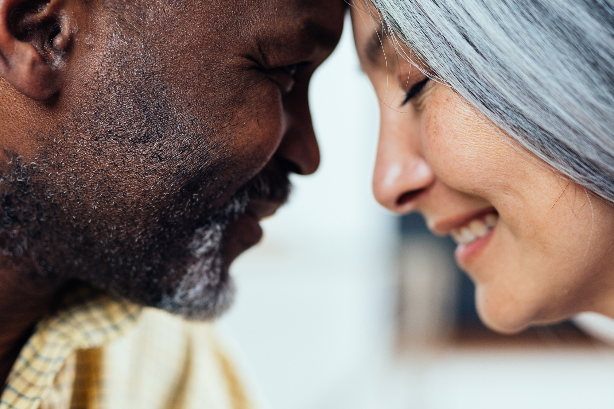 cinematic image of an happy multiethnic senior couple. Indoors Lifestyle moments at home. Concept about seniority and relationships