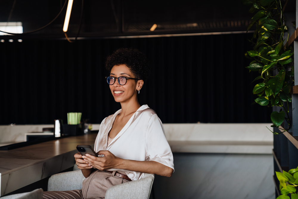 Businesswoman using cellphone for work