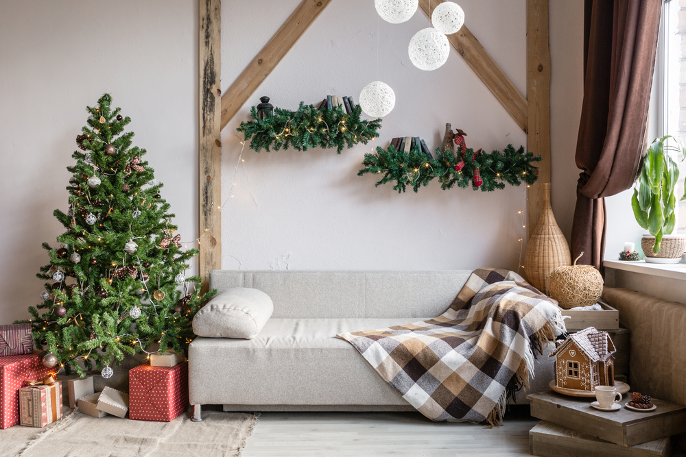 Xmas in morning living room. Sofa bed In christmas Interior. celebrate the new year and holidays. Christmas tree and gingerbread house