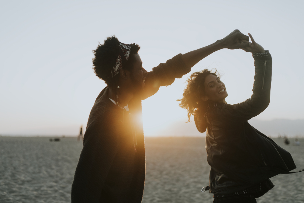 Happy couple dancing at the beach