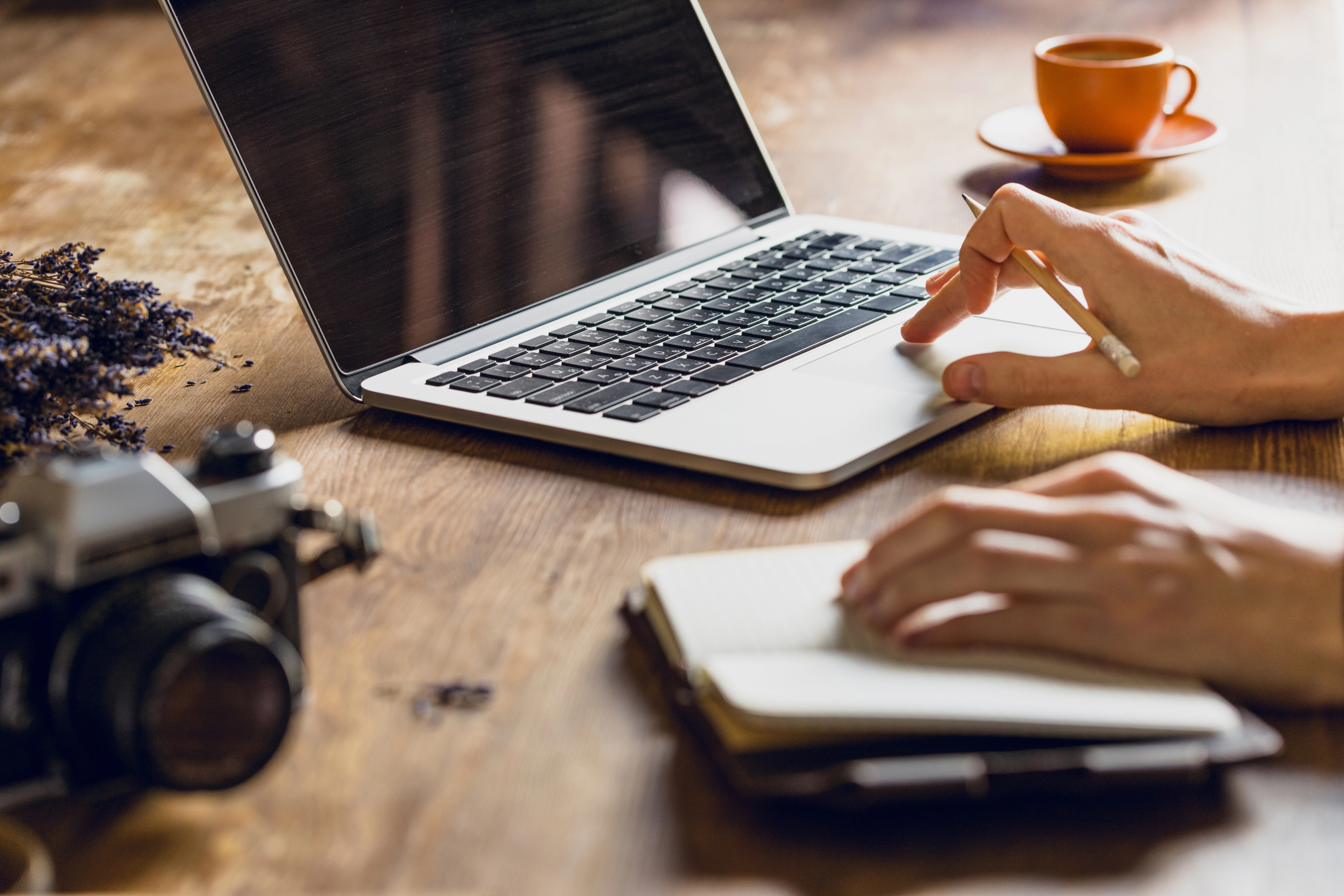 hands with a notebook on the table