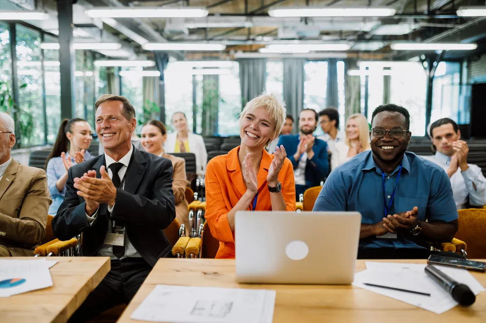 Cinematic image of a conference meeting. Business people sitting in a room listening to the motivator coach. Representation of a Self growth and improvement special event