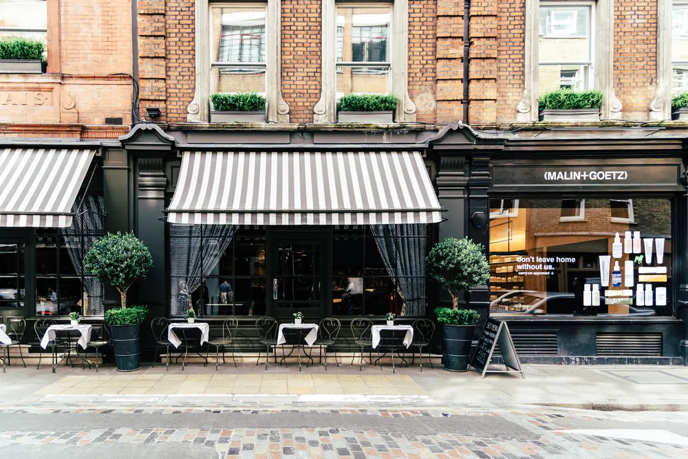 London, UK - May 15, 2019: Storefronts in Monmouth St in Seven Dials, Covent Garden. Located in the West End of London, is renowned for its luxury fashion stores