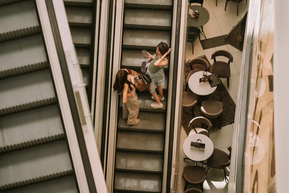 Teenage girls going up on the escalator