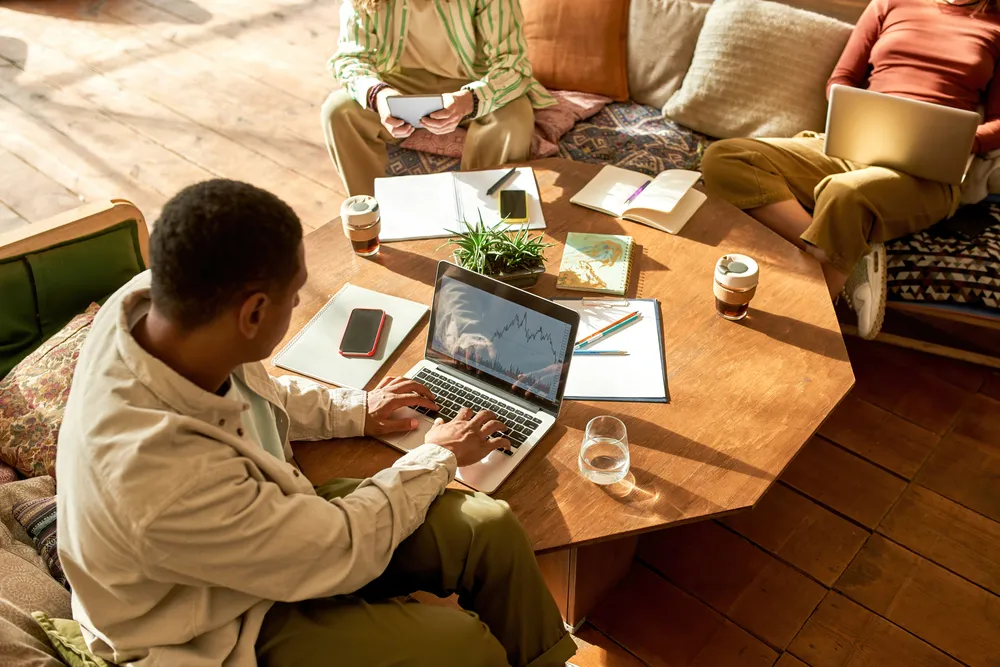 Young african american freelancer together with team